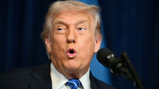 Donald Trump speaks into a microphone