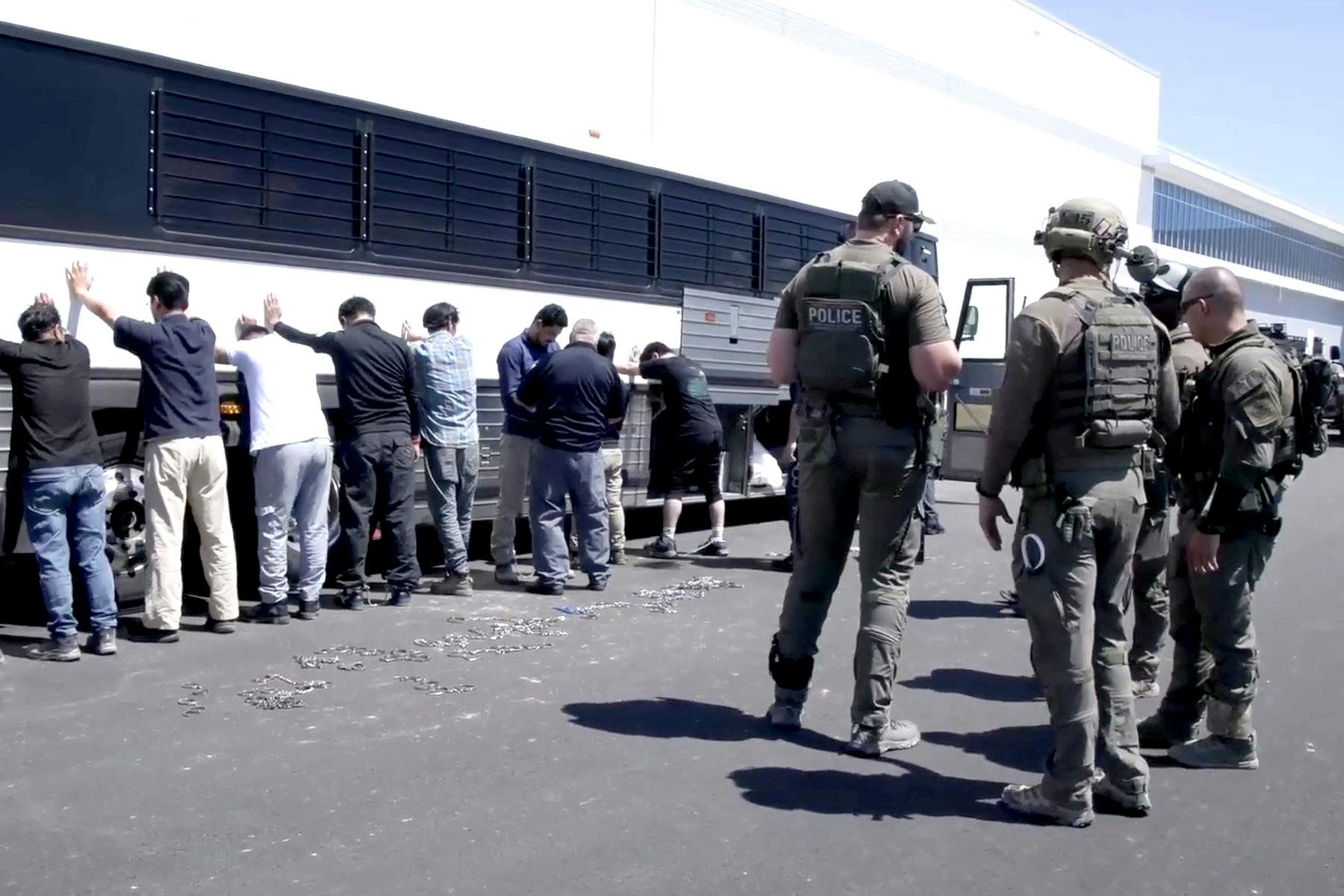 Employees waited to have their legs shackled at a Hyundai electric vehicle plant in Ellabell, Georgia, on Sept. 4. 