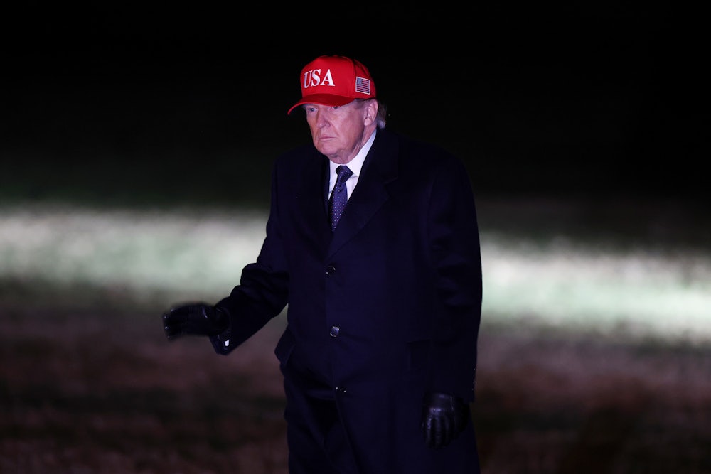 Donald Trump walks across the South Lawn as he returns to the White House.