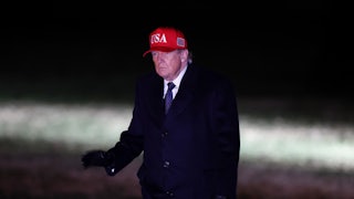 Donald Trump walks across the South Lawn as he returns to the White House.