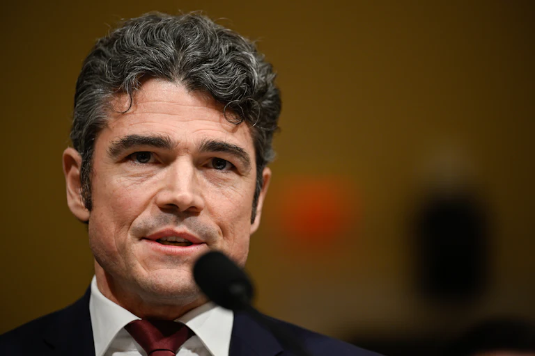 Joe Kent, the former director of the National Counterterrorism Center, speaks into a microphone.