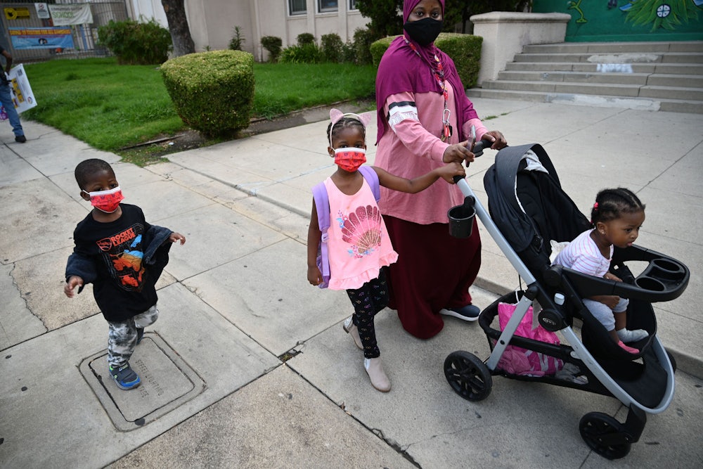 Mother drops children at preschool