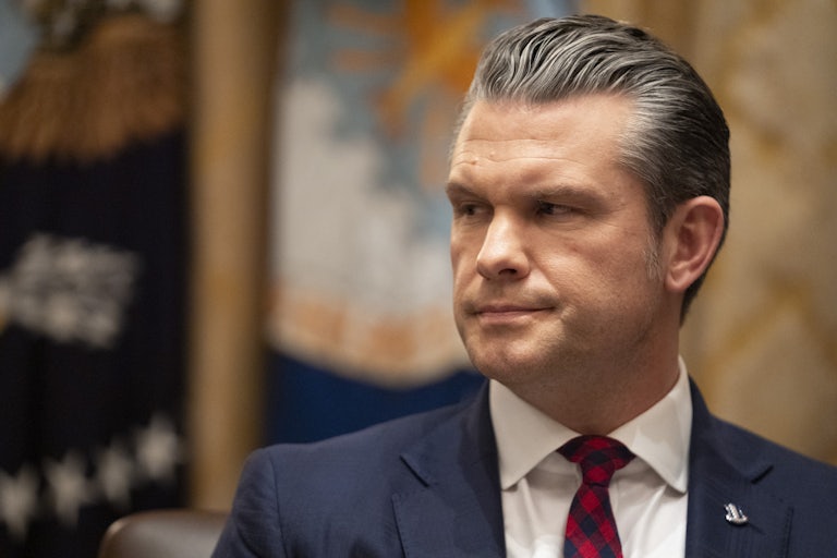 Defense Secretary Pete Hegseth frowns and looks to the side