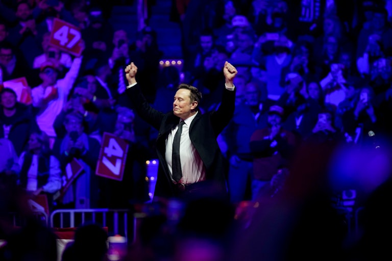 Elon Musk holds his fists above his head during Donald Trump’s pre-inauguration rally