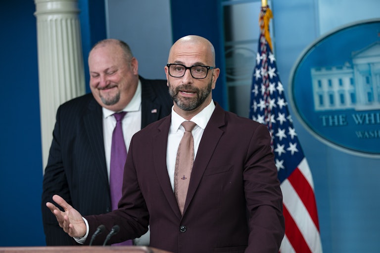 Dr. Demetre Daskalakis speaks at a White House news conference as Bob Fenton listens in the background. The two men are spearheading the administration's monkeypox response.