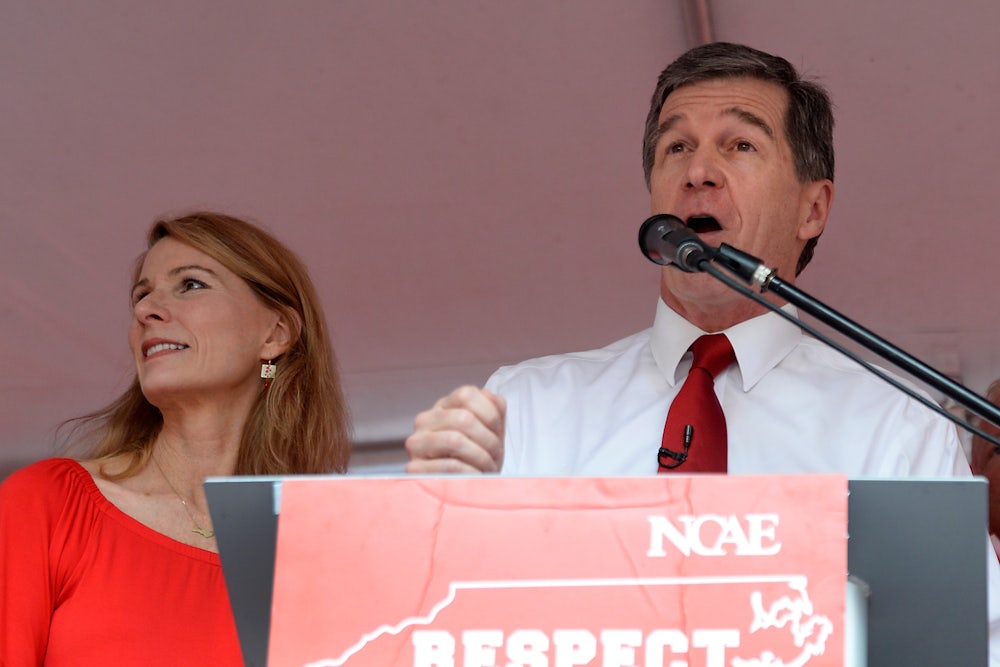 Governor Roy Cooper speaks at a podium.