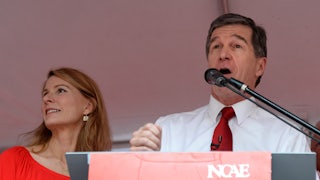 Governor Roy Cooper speaks at a podium.