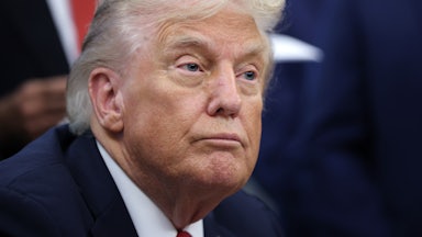 Donald Trump sits at his desk in the Oval Office