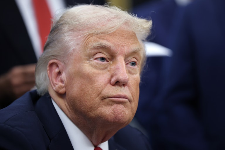 Donald Trump sits at his desk in the Oval Office