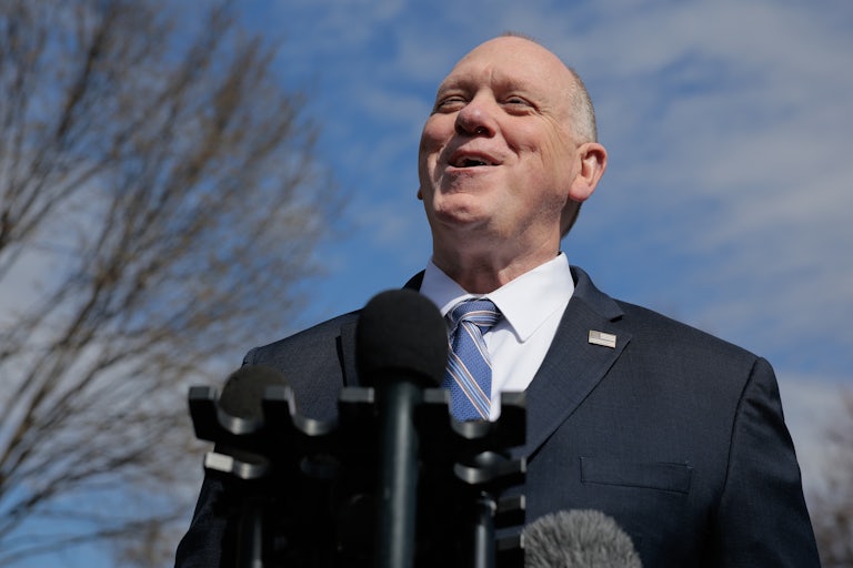 Tom Homan, who's bald, smiles