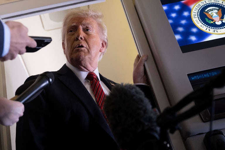 Donald Trump speaks to reporters on Air Force One