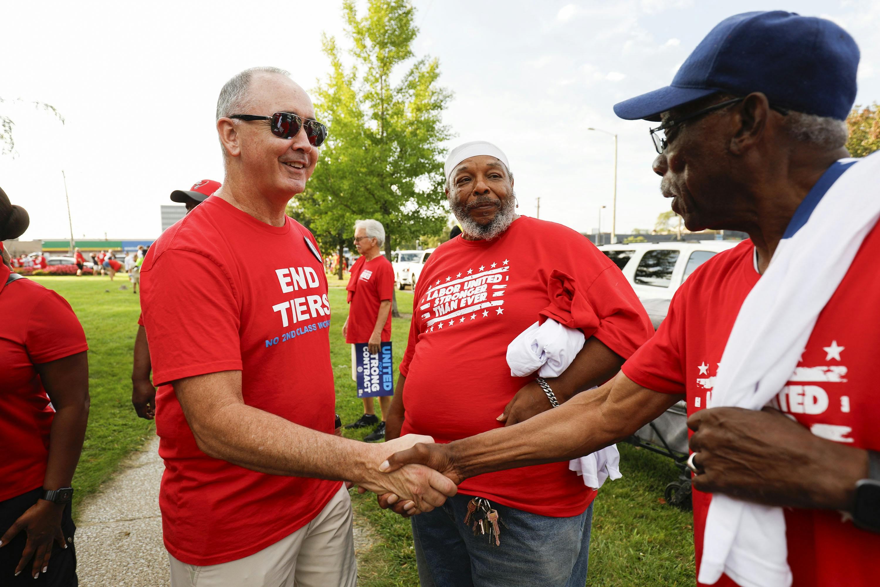 United Auto Workers President Shawn Fain talks with union members before marching in the Detroit Labor Day Parade on September 4, 2023 in Detroit, Michigan.