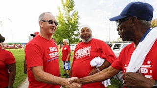 United Auto Workers President Shawn Fain talks with union members before marching in the Detroit Labor Day Parade on September 4, 2023 in Detroit, Michigan.