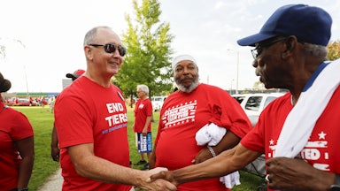 United Auto Workers President Shawn Fain talks with union members before marching in the Detroit Labor Day Parade on September 4, 2023 in Detroit, Michigan.