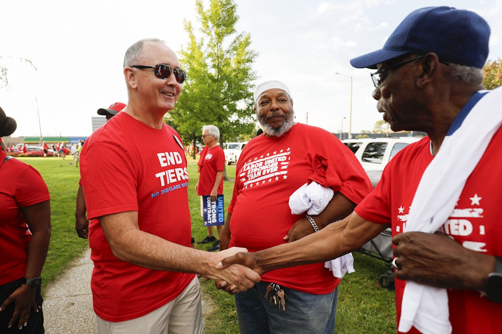 United Auto Workers President Shawn Fain talks with union members before marching in the Detroit Labor Day Parade on September 4, 2023 in Detroit, Michigan.