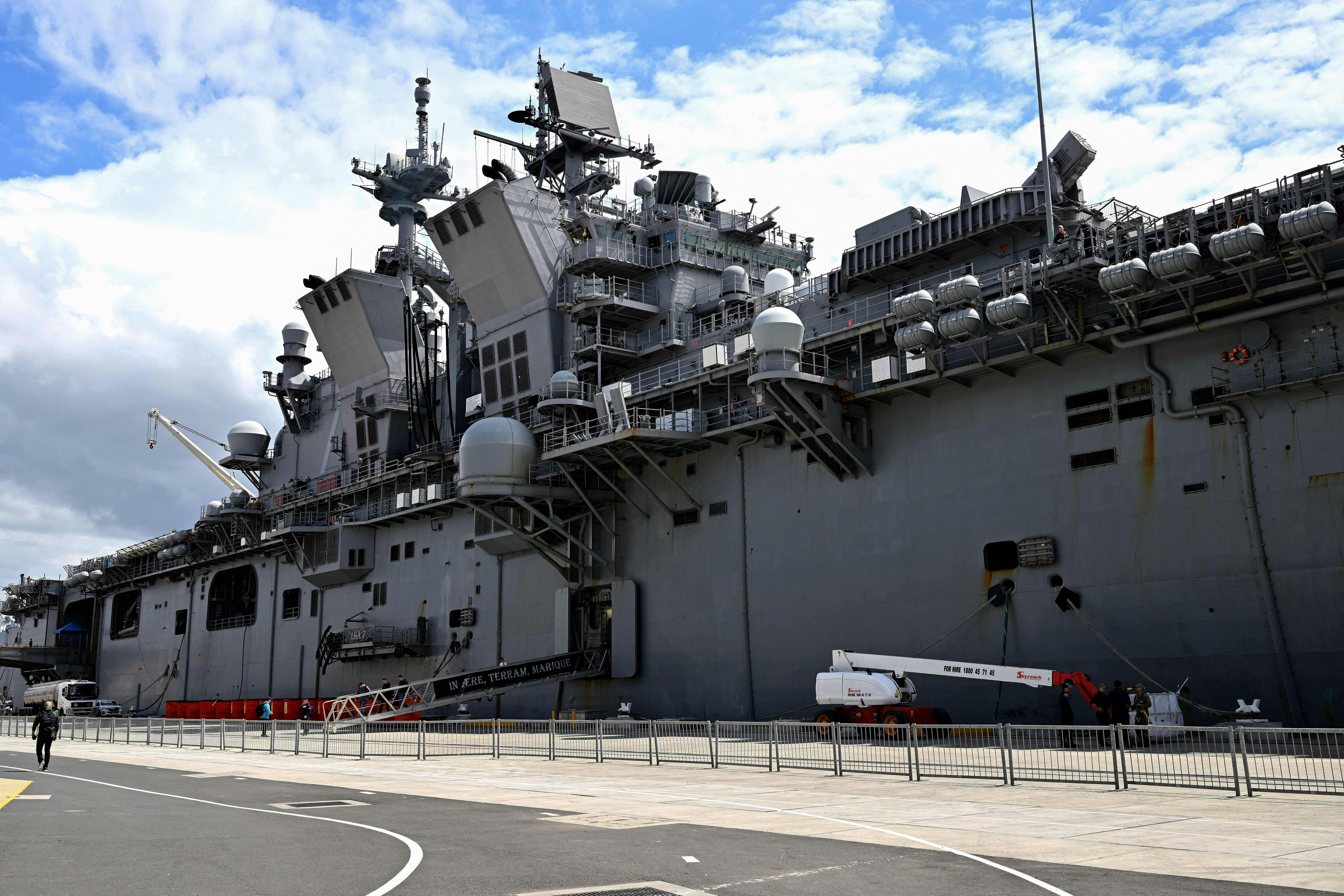 The USS Tripoli docked at a port 