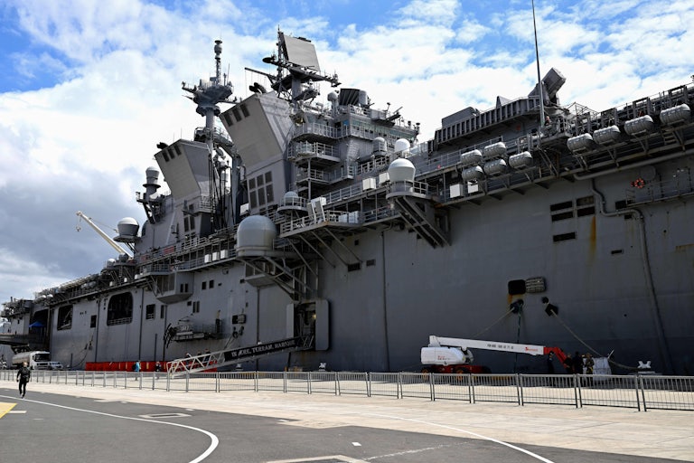The USS Tripoli docked at a port