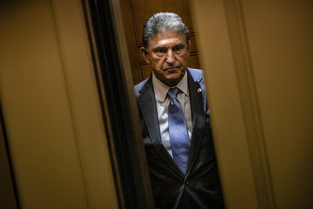 Senator Joe Manchin stands in an elevator as the door close