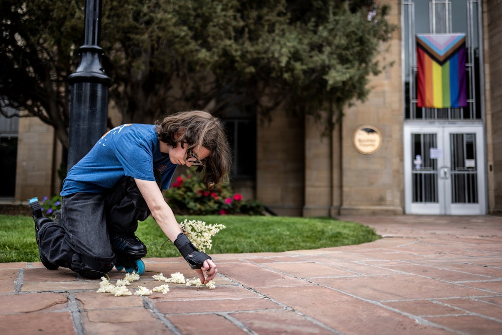 Wilbur Thayer, 17, of Boulder, lays flowers at the site of the attack outside the Boulder County Courthouse on June 2, 2025. A suspect is in custody after reportedly throwing incendiary devices at a group participating in an organized walk to show solidarity with hostages held by Hamas in Gaza.