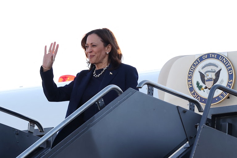 Kamala Harris waves as she gets off of the Air Force Two plane
