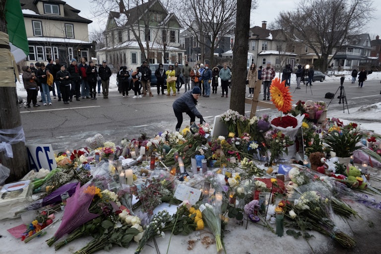 People stand around a memorial where Renee Good was shot in Minneapolis, Minnesota