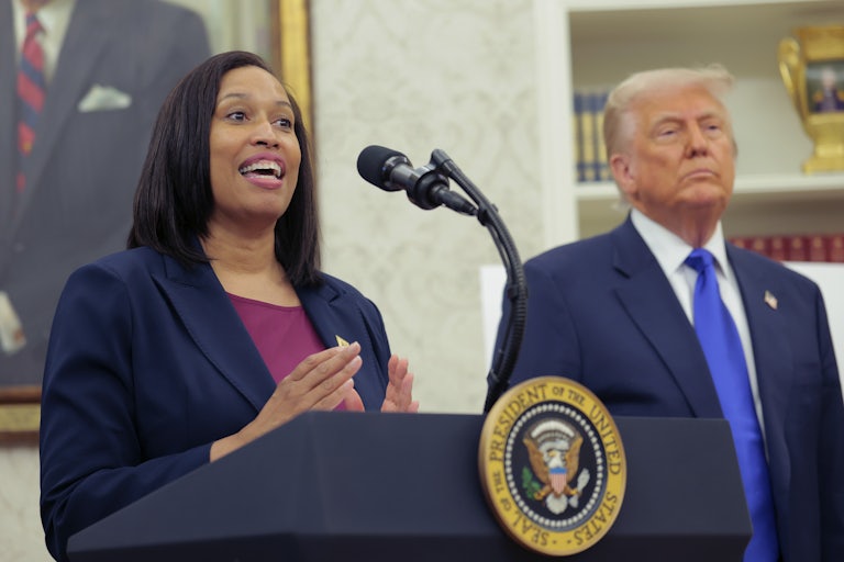 D.C. Mayor Muriel Bowser speaks at the presidential podium in the White House as Donald Trump stands beside her.