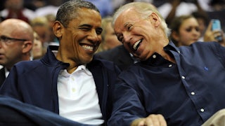 Joe Biden laughs and smiles as he looks at Barack Obama.
