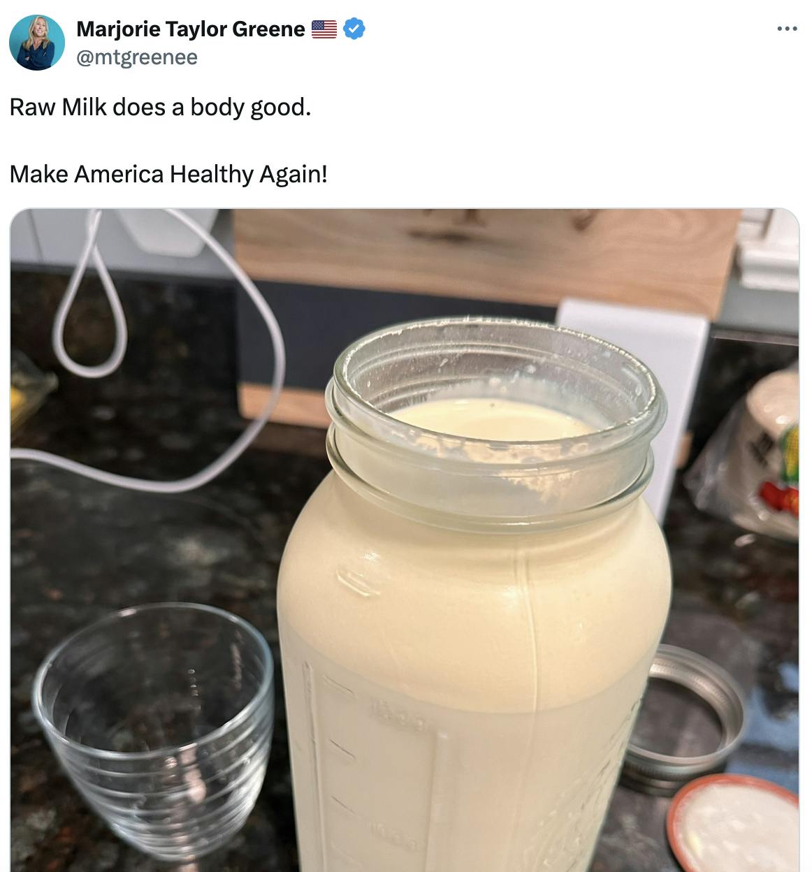 Twitter screenshot Marjorie Taylor Greene 🇺🇸 @mtgreenee: Raw Milk does a body good. Make America Healthy Again! (with photo of a large mason jar of milk and an empty glass next to it)