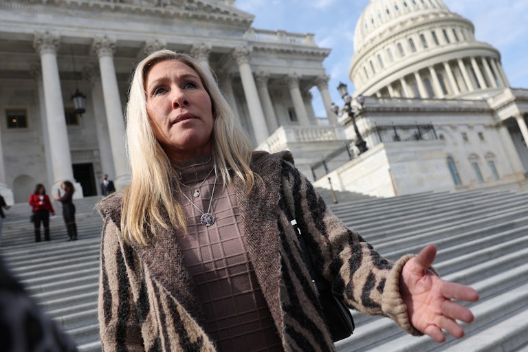 Marjorie Taylor Greene stands outside the Capitol.