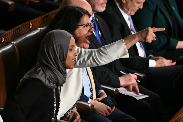 Representatives Rashida Tlaib and Ilhan Omar yell and point fingers during Trump’s State of the Union address.