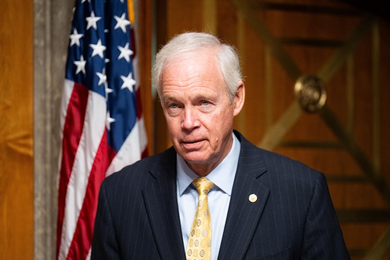 Senator Ron Johnson walks into a Senate hearing