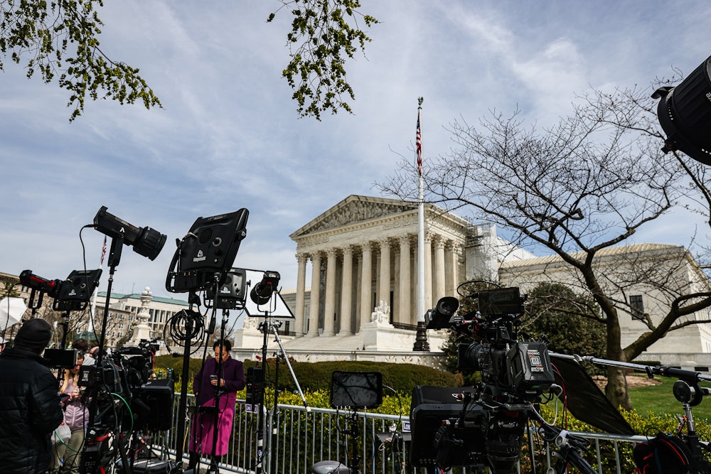 TV crews set up in front of the Supreme Court building.
