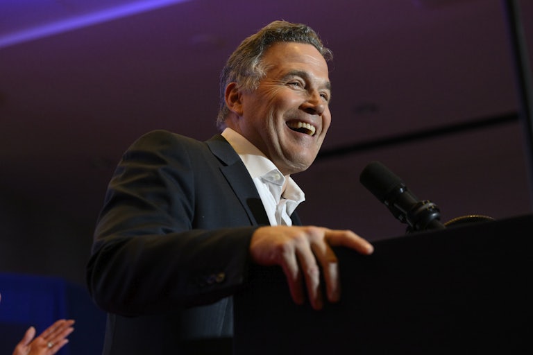 Dave McCormick smiles while standing at a podium