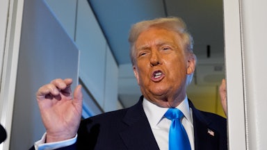 Donald Trump speaks angrily while making a hand gesture aboard Air Force One.