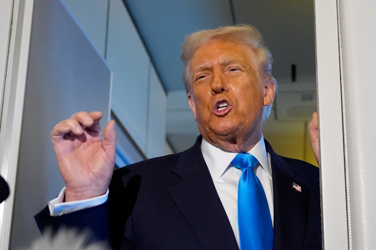 Donald Trump speaks angrily while making a hand gesture aboard Air Force One.