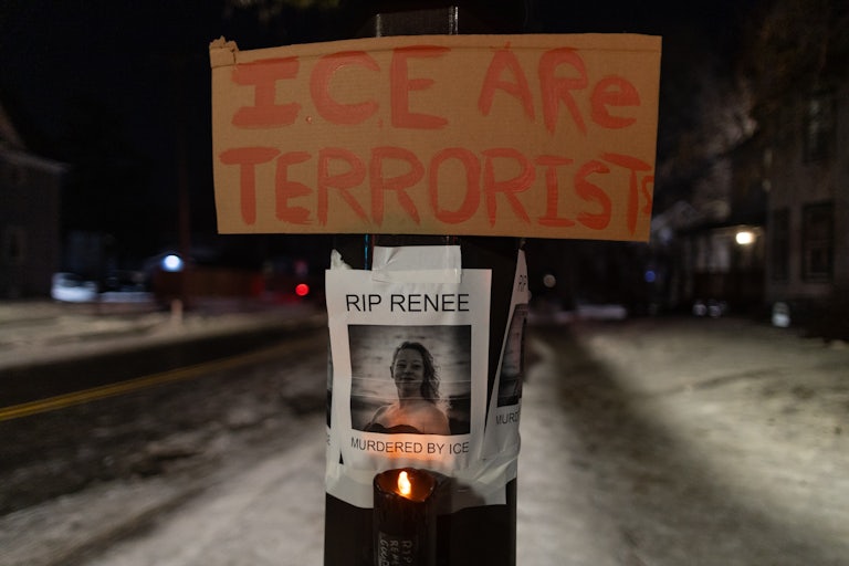 A sign that says "ICE are terrorist" hangs above a photo of Renee Good, who was shot dead by ICE in Minneapolis, Minnesota. The photo says, "RIP Renee. Murdered by ICE"