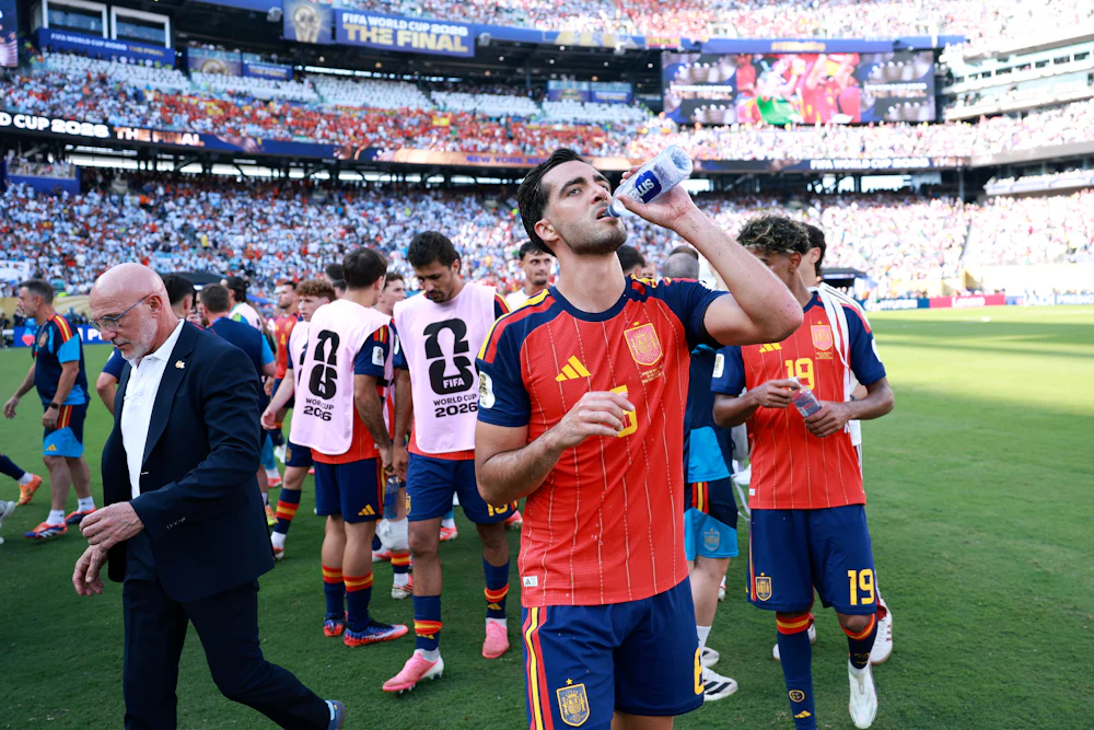 Mikel Merino of Spain takes a drink at a hydration break during the FIFA World Cup 2026 Final match between Spain and Argentina at “New York/New Jersey” Stadium in East Rutherford, New Jersey.