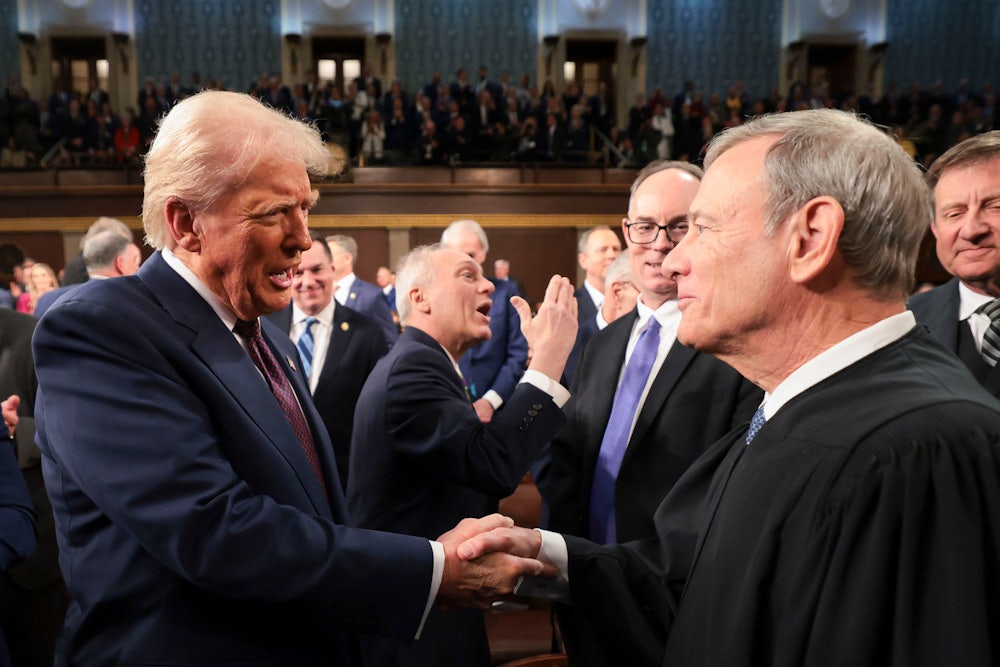 Trump greets John Roberts, chief justice of the Supreme Court, during a joint session of Congress