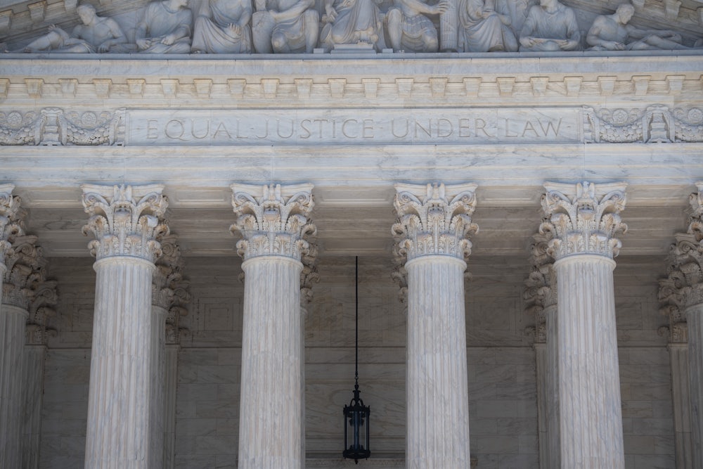 A close-up of the facade of the Supreme Court, where the words "Equal Justice Under Law" are etched.