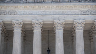 A close-up of the facade of the Supreme Court, where the words "Equal Justice Under Law" are etched.