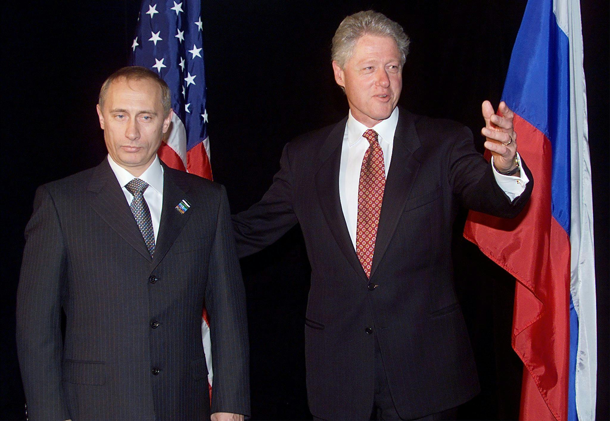 Bill Clinton and Vladimir Putin pose for a photo op