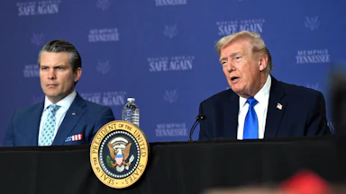 Defense Secretary Pete Hegseth sits next to President Donald Trump