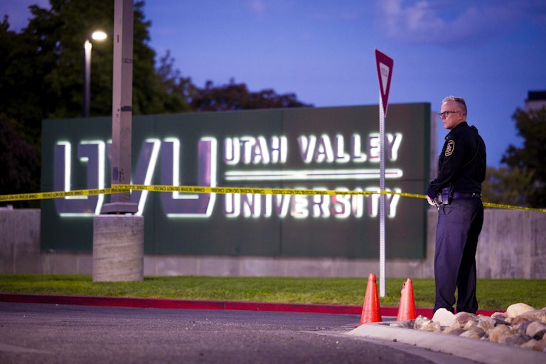 A law enforcement officer stands by crime scene tape on Utah Valley University campus, where Charlie Kirk was shot