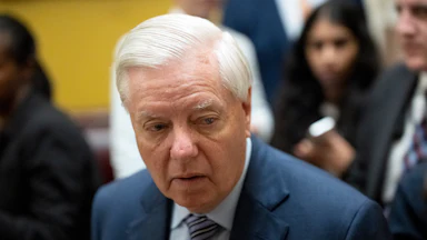 Senator Lindsey Graham looks to the side while walking in the Capitol