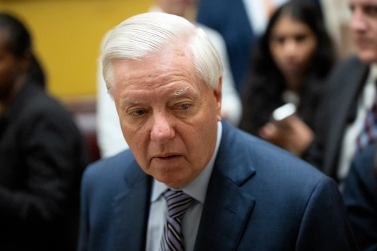 Senator Lindsey Graham looks to the side while walking in the Capitol