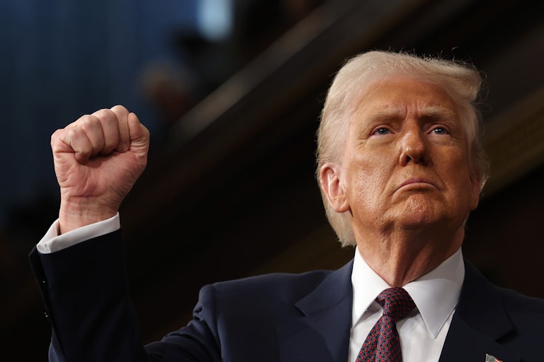 Donald Trump holds up his fist during his speech to a joint session of Congress
