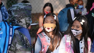 Students and parents arrive masked for the first day of the school year at Grant Elementary School in Los Angeles
