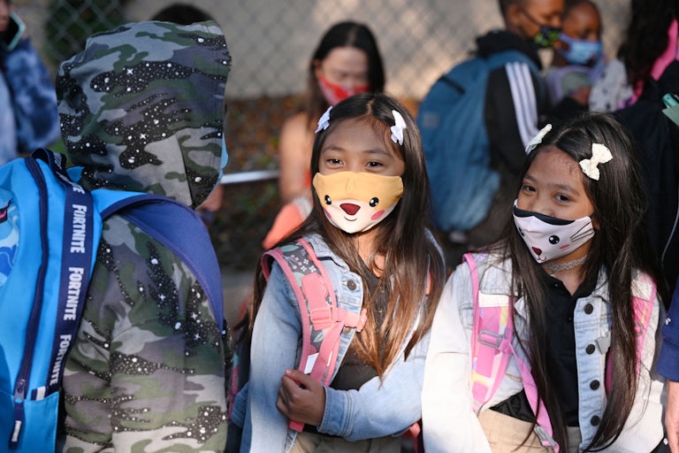 Students and parents arrive masked for the first day of the school year at Grant Elementary School in Los Angeles