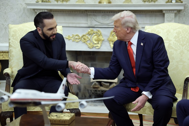 Donald Trump and Salvadoran President Nayib Bukele shake hands while seated in the Oval Office of the White House.