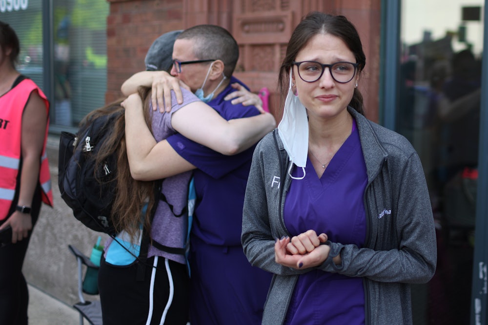 Workers at a family planning clinic watch an abortion rights march in Chicago